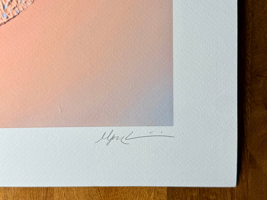 Close-up of the lower corner of the Nuqta print, showing the plaster texture of the original and the pencil signature on the white border