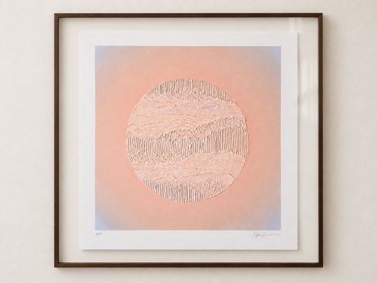 Nuqta framed and hung above a light wood console in daylight, showing the scale of the print in a room